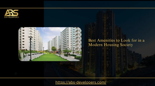 Modern residential housing society featuring multi-story apartment buildings, landscaped green parks, outdoor seating, and paved walking tracks.